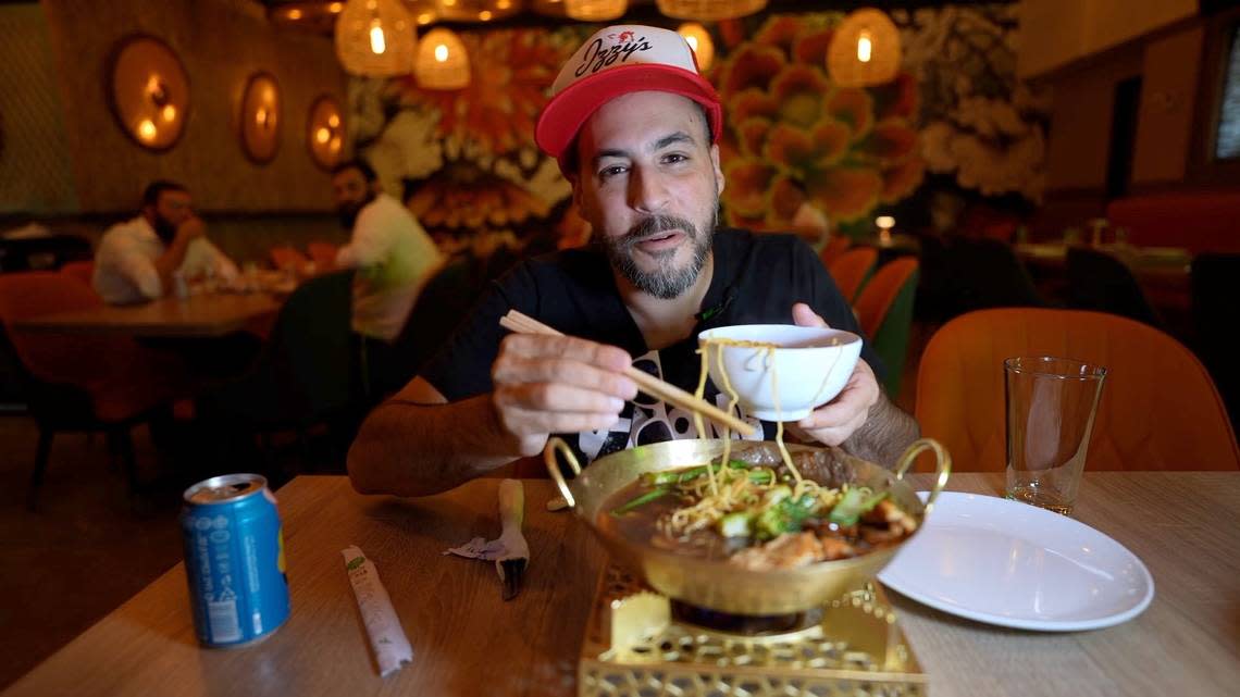 CW Silverberg, the host of ‘Schmoozing and Cruising,’ tries food at Bambu Pan Asian Kitchen, a kosher restaurant in North Miami Beach.