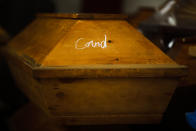 FILE - A coffin containing a deceased person who died with COVID-19 is stored in a crematorium's worship room, before cremation in Meissen, Germany, Jan. 11, 2021. Germany is set to mark 100,000 deaths from COVID-19 this week, passing a somber milestone that several of its neighbors crossed months ago but which some in Western Europe's most populous nation had hoped to avoid. (AP Photo/Markus Schreiber, File)