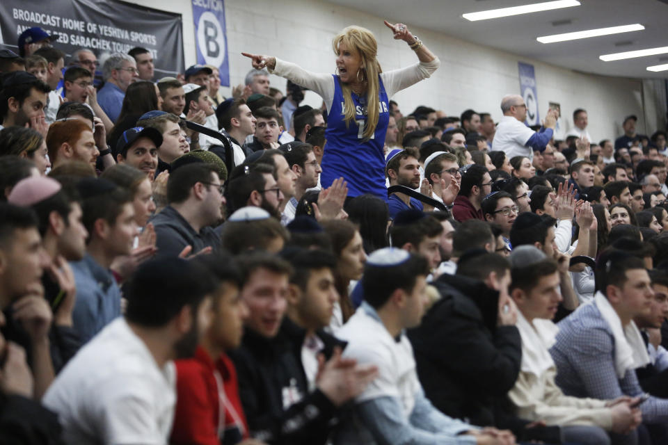 Laurel Turell, mother of guard Ryan Turell, cheers in the stands during the second half of the Skyline Conference men's basketball game between Yeshiva University and Farmingdale State College in New York, Feb. 27, 2020. Turell can often be heard starting chants and galvanizing Maccabee fans at games. (AP Photo/Jessie Wardarski)