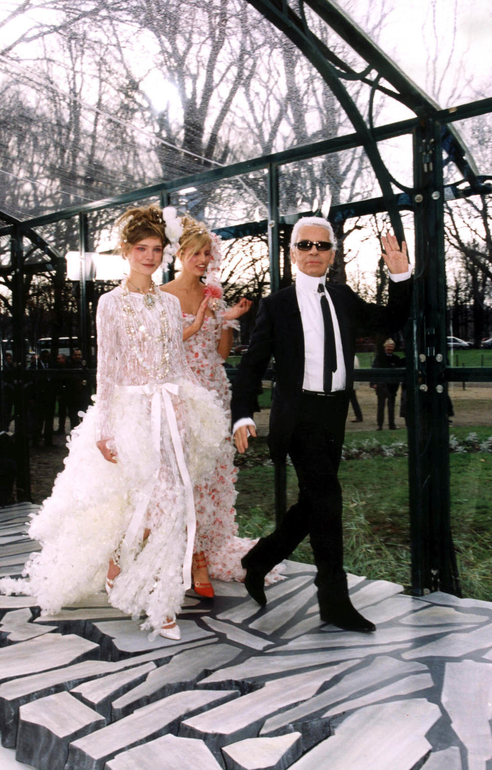 Models walk the runway with Lagerfeld at the Chanel spring/summer 2003 couture show on Jan. 21, 2003.&nbsp;