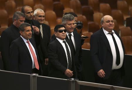 Former soccer star Diego Maradona (C) arrives to meet Pope Francis, for a special audience held before a special interreligious "Match for Peace", at the Paul VI hall at the Vatican September 1, 2014. REUTERS/Alessandro Bianchi