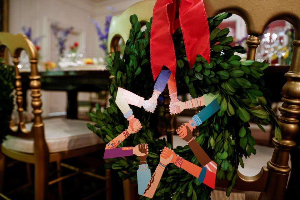 White House Christmas wreaths featuring interlocking hands in the shape of stars.