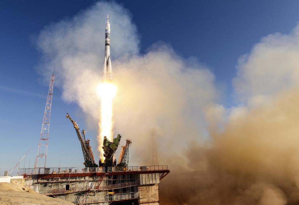 The Soyuz TMA-11M spacecraft decorated with the 2014 Sochi Winter Olympic Games logo and a blue-and-white snowflake pattern, blasts off from the launch pad at the Baikonur cosmodrome