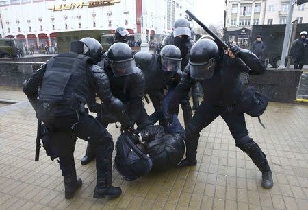 Law enforcement officers detain a participant of a rally, denouncing the new tax on those not in full-time employment and marking the 99th anniversary of the proclamation of the Belarussian People's Republic, in Minsk, Belarus, March 25, 2017. REUTERS/Vasily Fedosenko