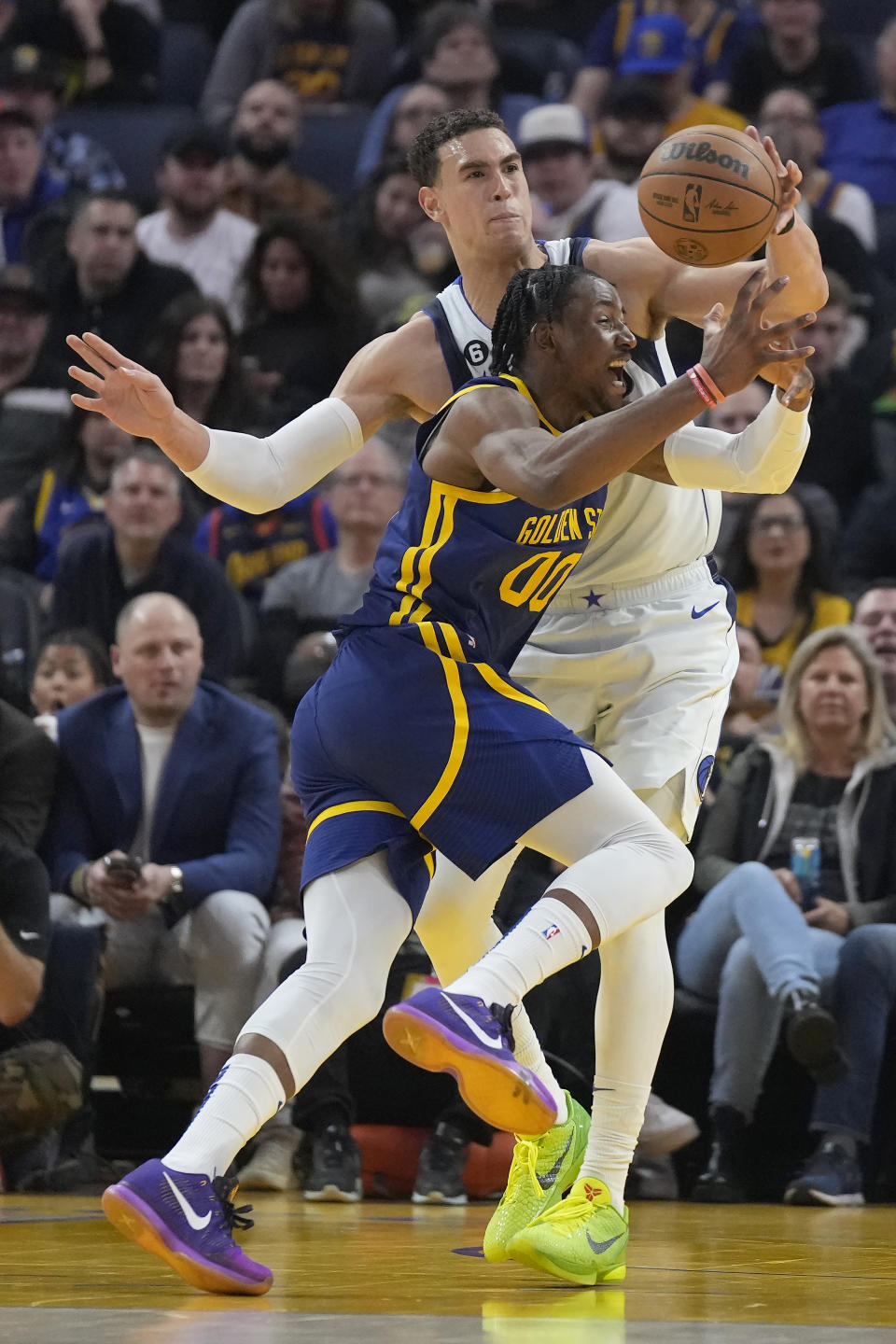 Golden State Warriors forward Jonathan Kuminga (00) loses the ball while defended by Dallas Mavericks center Dwight Powell during the first half of an NBA basketball game in San Francisco, Saturday, Feb. 4, 2023. (AP Photo/Jeff Chiu)