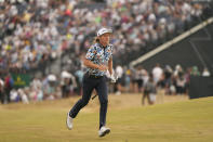 Cameron Smith, of Australia, runs up a hill to see his ball land on the 4th fairway during the third round of the British Open golf championship on the Old Course at St. Andrews, Scotland, Saturday July 16, 2022. (AP Photo/Gerald Herbert)