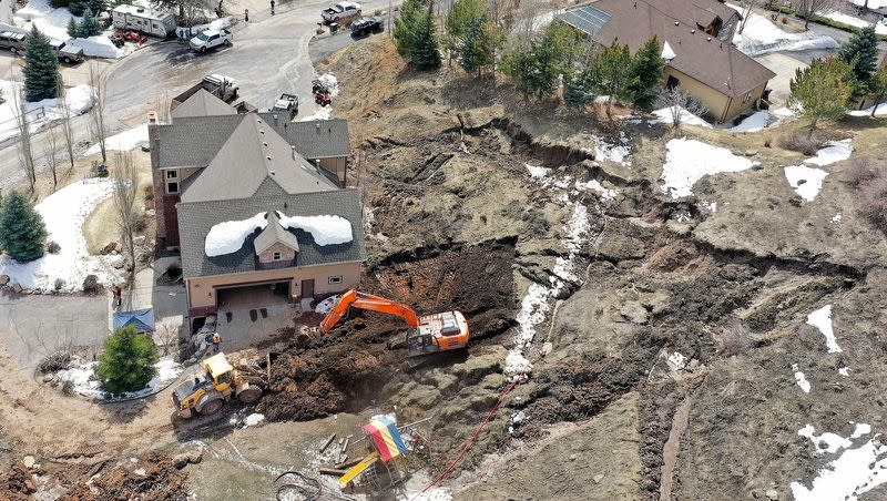 Crews work to remove mud at the scene of a mudslide near Mountain Green in Morgan County on Monday, April 17, 2023.