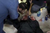 <p>A protester is attended after being hit by a rubber bullet shot by Spanish National Police near a polling station. (AP) </p>