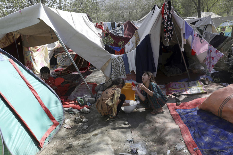 Internally displaced Afghans from northern provinces, who fled their home due to fighting between the Taliban and Afghan security personnel, take refuge in a public park Kabul, Afghanistan, Friday, Aug. 13, 2021. The Taliban have completed their sweep of the country's south on Friday, as they took four more provincial capitals in a lightning offensive that is gradually encircling Kabul, just weeks before the U.S. is set to officially end its two-decade war. (AP Photo/Rahmat Gul)