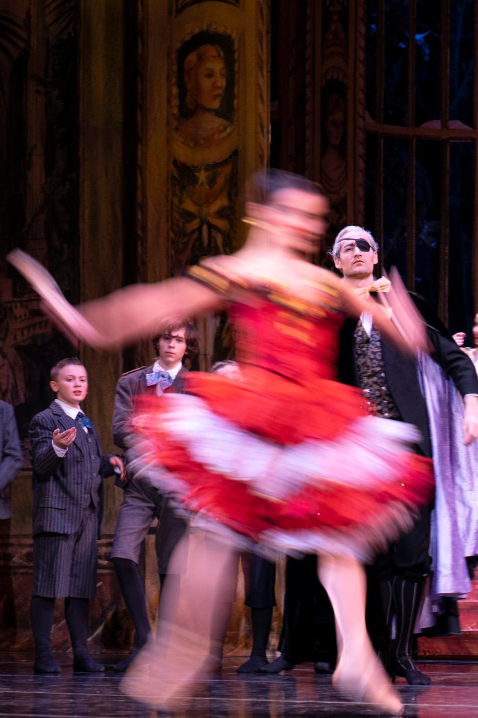 Herr Drosselmeyer, played by Austin Powers, wearing an eyepatch, watches the Spanish Doll, played by Francesca Dugarte, leap across the stage during a preview rehearsal for BalletMet’s performance of "The Nutcracker" at the Ohio Theatre.