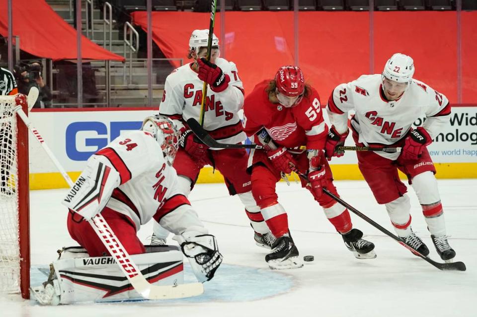 Detroit Red Wings left wing Tyler Bertuzzi (59) tries to get a shot on Carolina Hurricanes goaltender Petr Mrazek (34) in the second period of an NHL hockey game Thursday, Jan. 14, 2021, in Detroit. (AP Photo/Paul Sancya)