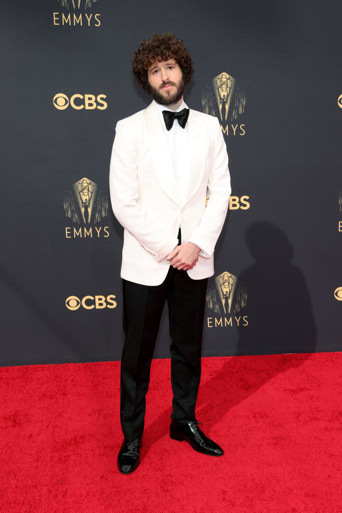 Dave Burd on the red carpet in a white suit jacket and black trousers