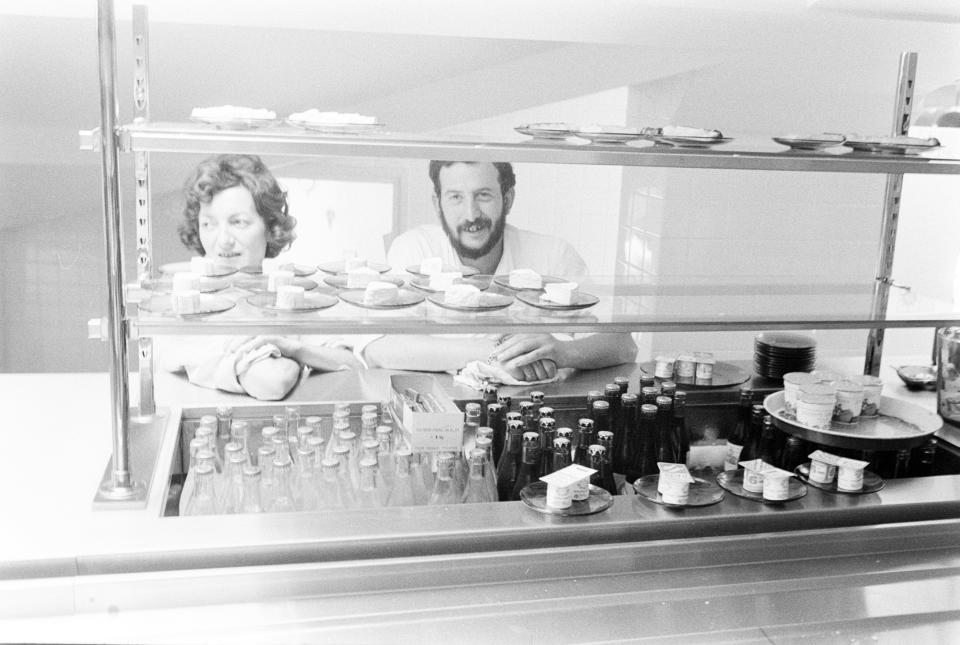 Chef Michel Barbier stands behind the counter with a cafeteria staff member. (Photo by Fairchild Archive/WWD/Penske Media via Getty Images)