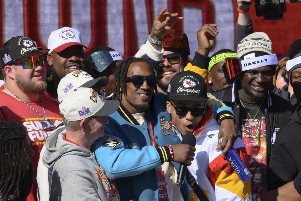 Kansas City Chiefs cornerback L'Jarius Sneed, center, hugs cornerback Trent McDuffie, right, as they speak to the crowd during the NFL football team’s Super Bowl celebration in Kansas City, Mo., Wednesday, Feb. 14, 2024. (AP Photo/Reed Hoffmann)