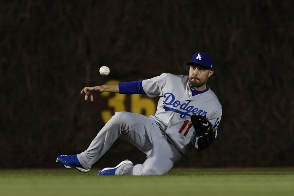 Los Angeles Dodgers center fielder A.J. Pollock catches a fly ball hit by Chicago Cubs' Cole Hamels during the third inning of a baseball game Wednesday, April 24, 2019, in Chicago. (AP Photo/Paul Beaty)