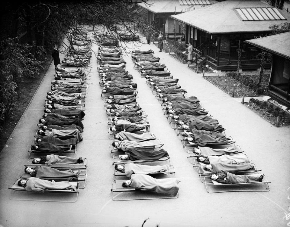 Children suffering from TB rest outdoors at Springwell House, London, in the 1930s.