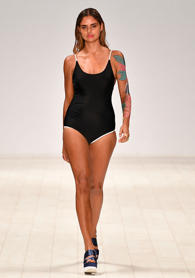 Aussie model Samantha Harris wore a black and white swimsuit and a sleeve of tattoos during the Swim show at Mercedes-Benz Fashion Week Australia.