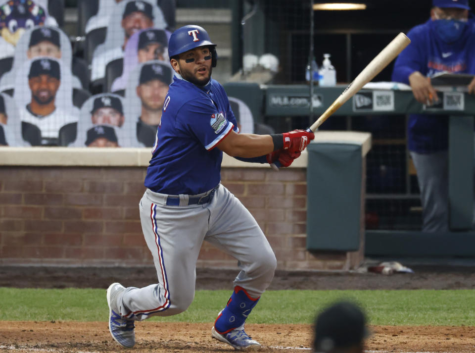 Texas Rangers' Jose Trevino follows the flight of his single off Colorado Rockies starting pitcher German Marquez in the fifth inning of a baseball game Saturday, Aug. 15, 2020, in Denver. (AP Photo/David Zalubowski)