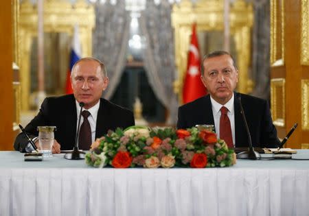 Russian President Vladimir Putin (L) talks during a joint news conference with his Turkish counterpart Tayyip Erdogan following their meeting in Istanbul, Turkey, October 10, 2016. REUTERS/Osman Orsal