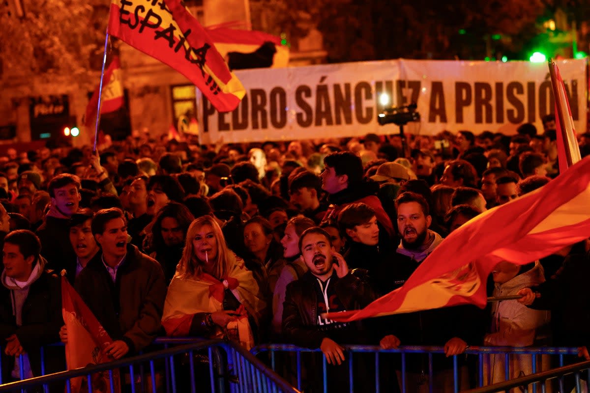 Demonstrators chant slogans during a protest near Spain's Socialists Party (PSOE) headquarters, following acting Prime Minister Pedro Sanchez's negotiations for granting an amnesty to people involved with Catalonia's failed 2017 independence bid (REUTERS)
