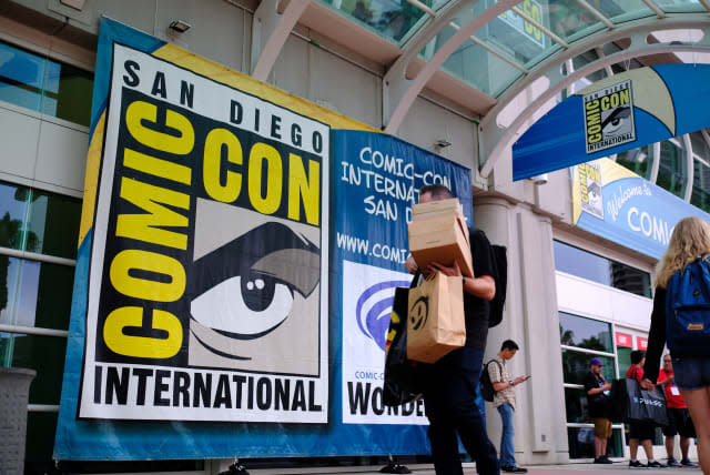 People walk in front of the Convention Center during Comic Con in San Diego, California on July 17, 2019. (Photo by Chris Delmas / AFP)        (Photo credit should read CHRIS DELMAS/AFP via Getty Images)