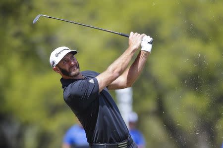 Mar 21, 2018; Austin, TX, USA; Dustin Johnson of the United States hits his approach on the first hole during the first round of the WGC - Dell Technologies Match Play golf tournament at Austin Country Club. Mandatory Credit: Erich Schlegel-USA TODAY Sports