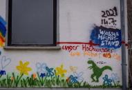 Children have painted the wall of a house with letters reading "maximum water hight on July 14, 2021" and "our flood was higher than.." showing a dinosaur in the village of Dernau in the Ahrtal valley, southern Germany, Tuesday, Dec.14, 2021. The floods in July claimed almost 200 lives, many of them in the narrow Ahr Valley that's best known for its vineyards and as a picturesque hiking destination. (Photo/Michael Probst)