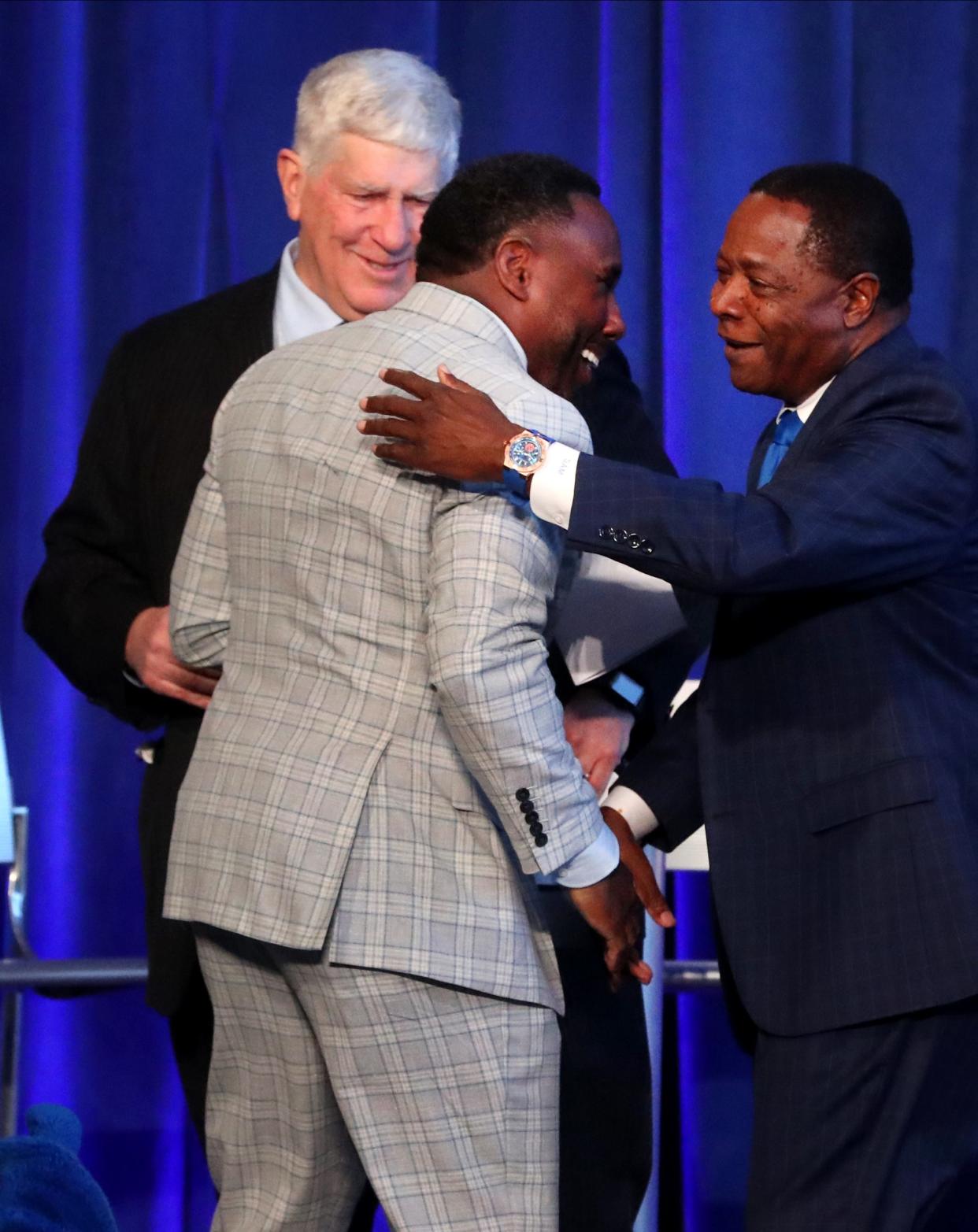 MTSU Director of Athletics Chris Massaro, left, looks on as the new MTSU head football coach Derek Mason, center gets a hug from MTSU President Sidney McPhee, right as MTSU officially announces Derek Mason, the former Vanderbilt head football coach as the new MTSU head football coach on Wednesday, Dec. 6, 2023, during a press conference in the Student Union Building on campus.