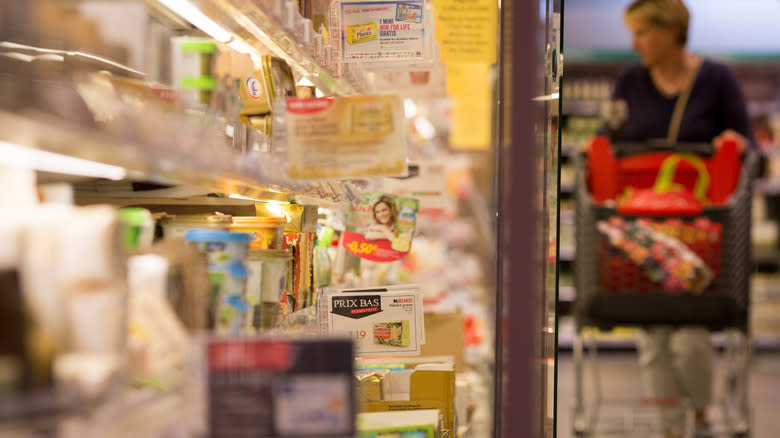 Woman browsing dairy aisle