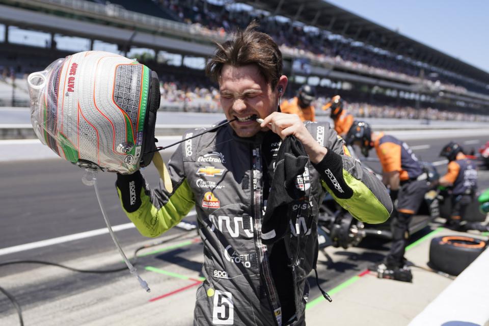 Pato O'Ward, of Mexico, takes off his helmet following the final practice for the Indianapolis 500 auto race at Indianapolis Motor Speedway, Friday, May 26, 2023, in Indianapolis. (AP Photo/Darron Cummings)