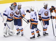 New York Islanders goaltender Semyon Varlamov (40) celebrates with teammates Mathew Barzal (13) and Jordan Eberle (7) after they eliminated the Washington Capitals following an NHL Stanley Cup playoff hockey game in Toronto, Thursday, Aug. 20, 2020. (Nathan Denette/The Canadian Press via AP)