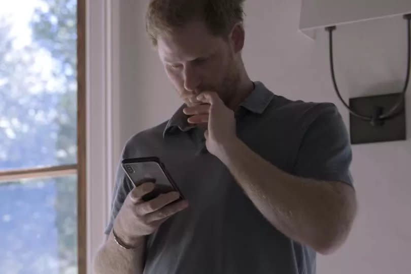 Prince Harry reading a message sent to him by his brother William