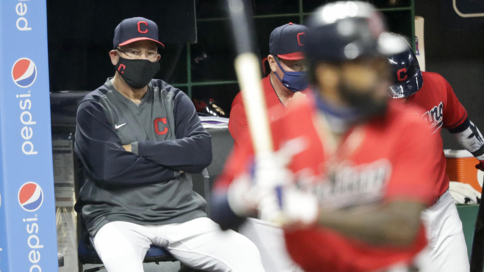 Cleveland Indians manager Terry Francona, left, watches as Cleveland Indians' Delino DeShields bats in the fifth inning in a baseball game against the Chicago Cubs, Tuesday, Aug. 11, 2020, in Cleveland. (AP Photo/Tony Dejak)