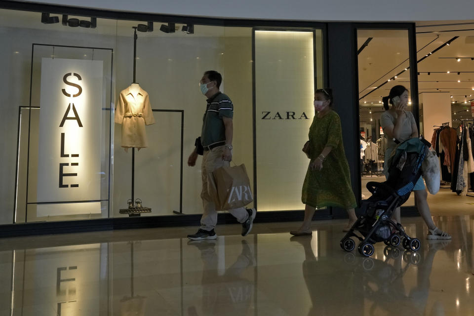 A man with a shopping bag walks out from a ZARA flagship store at a shopping mall in Bejing, Wednesday, June 21, 2023. Foreign companies are shifting investments and their Asian headquarters out of China as confidence plunges following the expansion of an anti-spying law and other challenges, a business group said Wednesday. (AP Photo/Andy Wong)