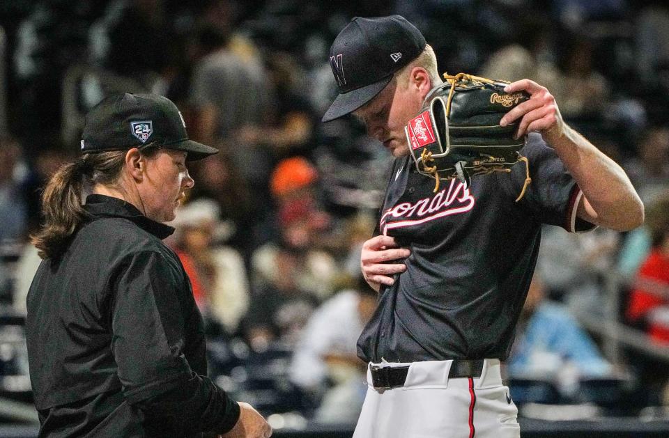 Umpire Jen Pawol checks pitcher Jake Irvin, 74, in between innings for any illegal substances during a training game between the Houston Astros and Washington Nationals on Saturday, February 24, 2024 at the Cacti Stadium in West Palm Beach.