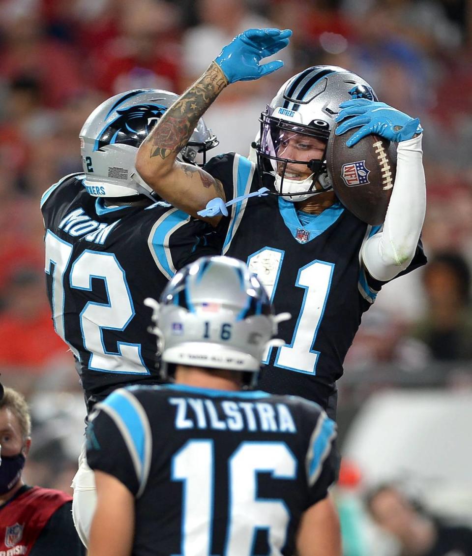 Carolina Panthers wide receiver Robby Anderson, right, celebrates his touchdown pass reception with tackle Taylor Moton, left, during fourth quarter action against the Tampa Bay Buccaneers at Raymond James Stadium in Tampa, Fl. on Sunday, January 9, 2022. The Panthers lost to the Buccaneers 41-17.