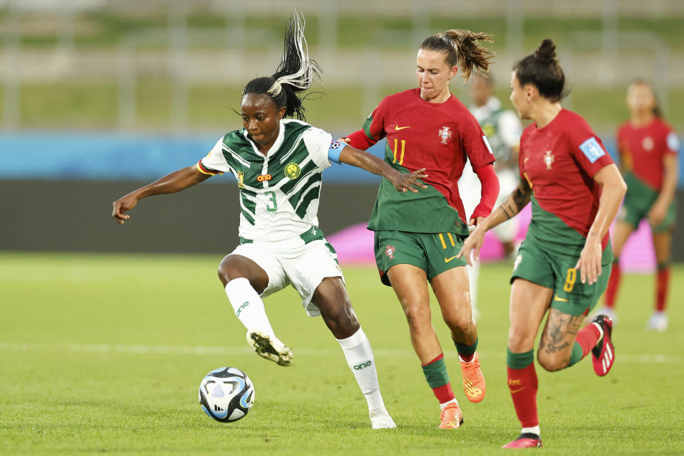 Ajara Nchout, left, of Cameroon battles for the ball with Portugal's Tatiana Pinto and Ana Borges, right, during their FIFA women's World Cup qualifier in Hamilton, New Zealand, Wednesday, Feb. 22, 2023. (Martin Hunter/Photosport via AP)