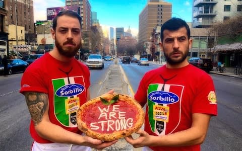 Italian pizza chefs at the New York branch of the Sorbillo Pizzeria chain send a message to their colleagues in Naples - Credit: Pizzeria Sorbillo