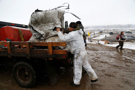 Protesters load equipment onto vehicles as they prepare to evacuate the main opposition camp against the Dakota Access oil pipeline near Cannon Ball, North Dakota, U.S., February 22, 2017. REUTERS/Terray Sylvester