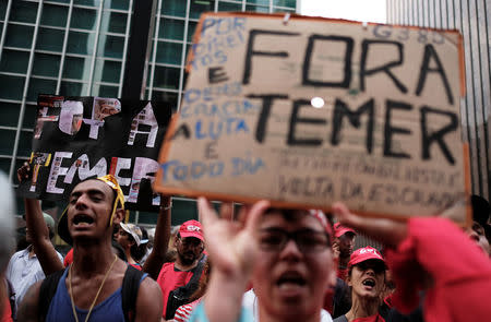 Members of Brazil's Homeless Workers' Movement (MTST) hold placards reading "Out Temer" during a vote on whether the Congress allows charges against President Michel Temer to be sent to the Supreme Court for trial, in Sao Paulo, Brazil October 25, 2017. REUTERS/Nacho Doce