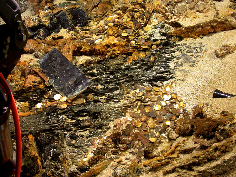 A photo released by Odyssey Marine Exploration snapped by a remote-controlled underwater vehicle shows piles of gold coins on the wreck of the S.S. Republic during salvage operations in Nov. 2003 off the coast of Georgia. Experts estimate there are 20,000 to 30,000 coins at the site 1,700 feet below the surface of the Atlantic Ocean, worth perhaps as much as $180 million. The S.S. Republic was carrying 59 passengers and a load of gold coins from New York to New Orleans when it sank in a hurricane offSavannah, Ga., on Oct. 25, 1865, according to newspaper accounts and other historical records. (AP Photo/Odyssey Marine Exploration)