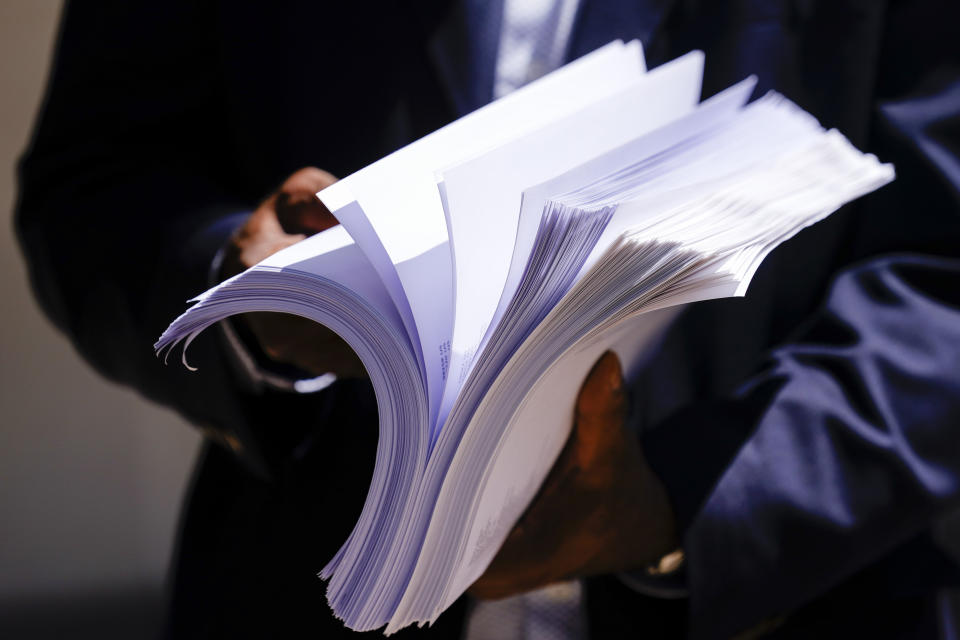 Former NFL player Ken Jenkins holds thousands of petitions demanding equal treatment for everyone involved in the settlement of concussion claims against the NFL, before delivering them to the federal courthouse in Philadelphia, Friday, May 14, 2021. Thousands of retired Black professional football players, their families and supporters are demanding an end to the controversial use of “race-norming” to determine which players are eligible for payouts in the NFL’s $1 billion settlement of brain injury claims, a system experts say is discriminatory. (AP Photo/Matt Rourke)