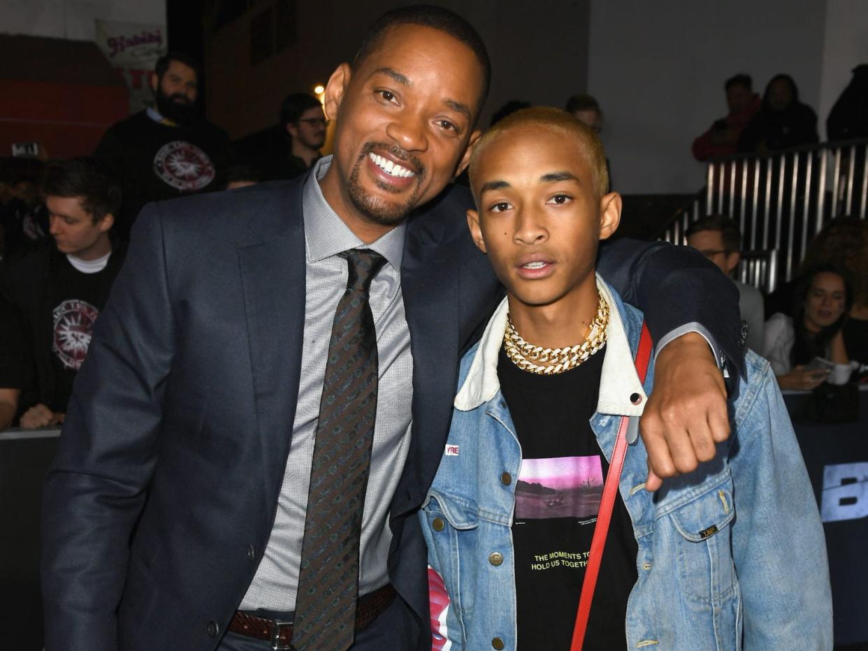 Will Smith and Jaden Smith embrace on a red carpet in December 2017.