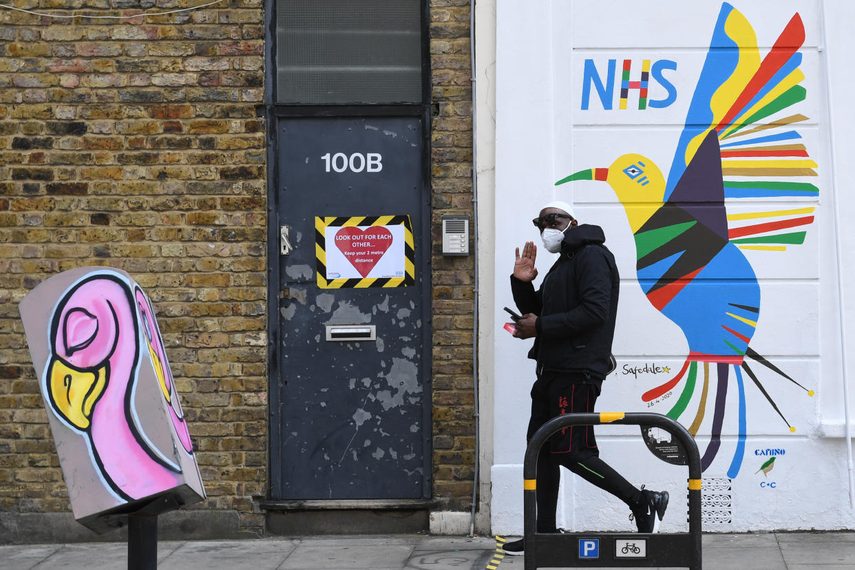 A person walks past a mural painted on the side of Safedale pharmacy in Stoke Newington Church St, London in support of the NHS, as the UK continues in lockdown to help curb the spread of the coronavirus. (Photo by Stefan Rousseau/PA Images via Getty Images)