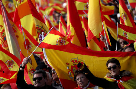 People listen to the national anthem as they call for Spanish unity during a gathering at Colon Square in Madrid, Spain, December 1, 2018. REUTERS/Sergio Perez