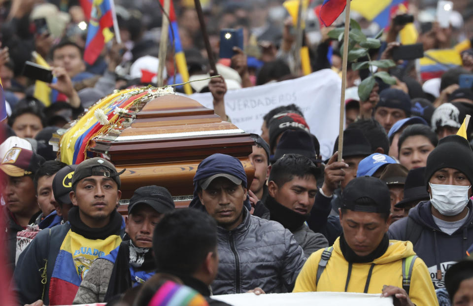 Anti-government protesters carry the coffin that contain the remains of indigenous leader Inocencio Tucumbi, who protesters say died during the country's recent unrest, in a procession leading into the Casa de Cultura in Quito, Ecuador, Thursday, Oct. 10, 2019. The government’s removal of fuel subsidies last week plunged Ecuador into upheaval, triggering protests, looting, vandalism, clashes with security forces, the blocking of highways and the suspension of parts of its vital oil industry. (AP Photo/Dolores Ochoa)