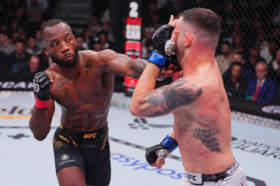 LAS VEGAS, NEVADA - DECEMBER 16: (L-R) Leon Edwards of Jamaica punches Colby Covington in the UFC welterweight championship fight during the UFC 296 event at T-Mobile Arena on December 16, 2023 in Las Vegas, Nevada. (Photo by Jeff Bottari/Zuffa LLC via Getty Images)