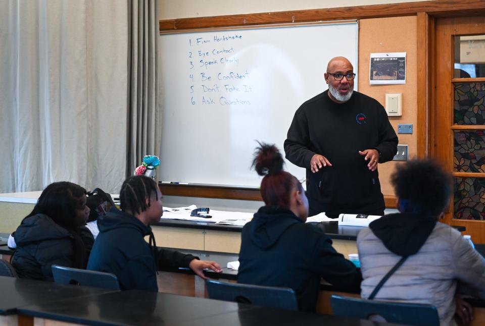 United Mentoring Program Director Karry Smith talks with Sexton High School students, Thursday, Dec. 21, 2023, during an after-school mentoring session.