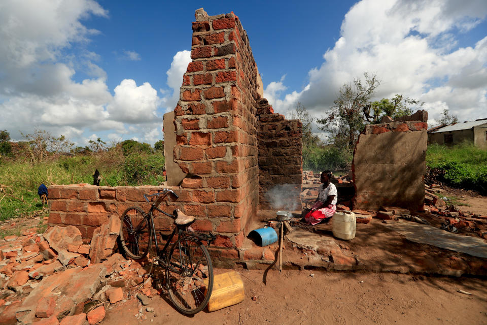 Ester Thoma cooks at her damaged house in the aftermath of Cyclone Idai, in the village of Cheia, which means "Flood" in Portuguese, near Beira, Mozambique April 1, 2019. (Photo: Zohra Bensemra/Reuters)  
