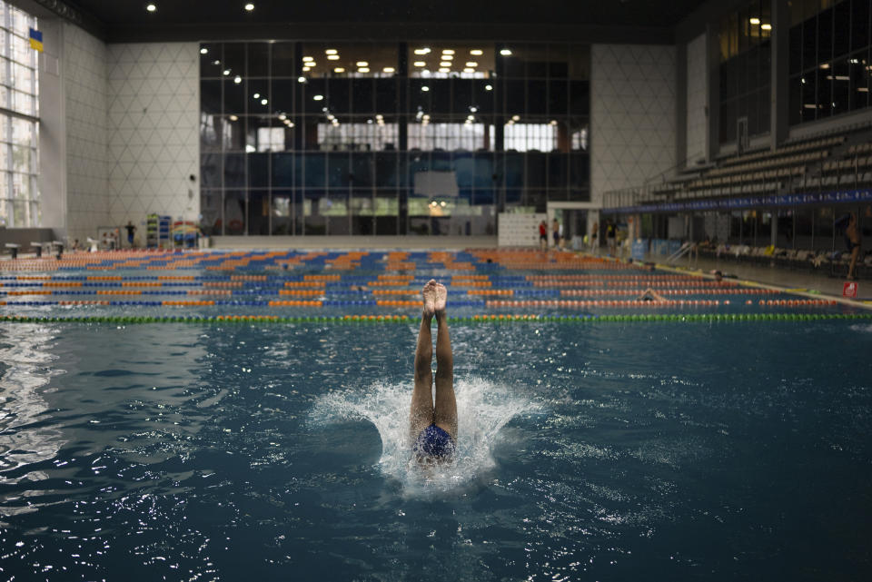 A child dives into the water during training in Kyiv's Liko Diving School, Wednesday, July 3, 2024. At Ukraine's largest diving school, 50% of the most promising children here are gone, said Illia Tseliutin, head coach of Ukraine's national diving team. Two of the 20 coaches joined the army and three fled the country. (AP Photo/Alex Babenko)